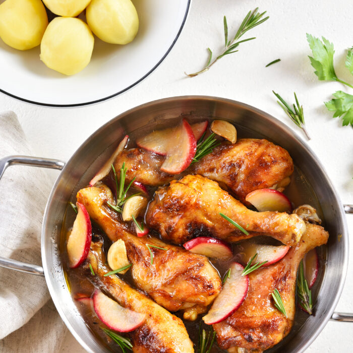 Chicken,Drumsticks,Baked,With,Apples,And,Herbs.,White,Background,,Top