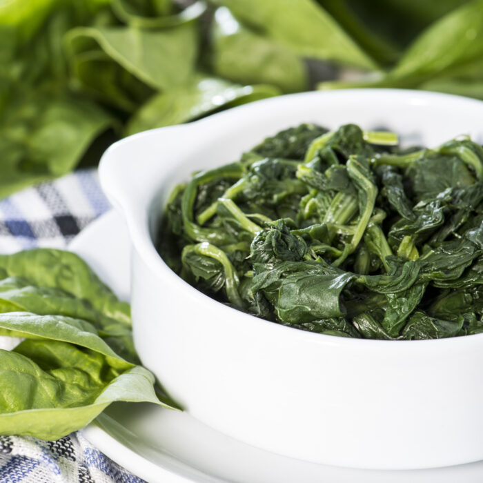 Portion,Of,Cooked,Spinach,On,Wooden,Background